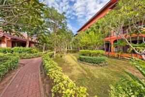 a brick path in front of a building at Pinnacle Samui Resort in Mae Nam