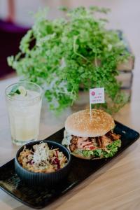 a black plate with a sandwich and a bowl of food at Apartment-Hotel Schaffenrath in Salzburg