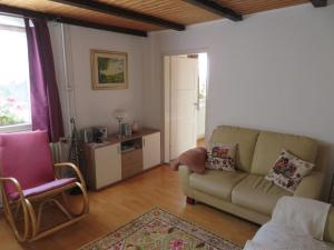 a living room with a couch and a chair at Haus Antonis in Triberg