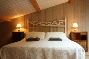 a bedroom with a bed with two pillows on it at Le Patio in Parentignat
