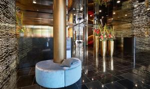 a lobby with a pillar and flowers in a building at Living Hotel Das Viktualienmarkt in Munich