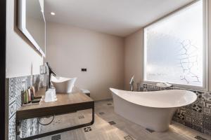 a bathroom with a large window and a tub at Les Jardins du Mess in Verdun-sur-Meuse +33 photos