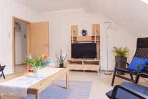a living room with a coffee table and a tv at Apartment Breite Str. 83 in Witten