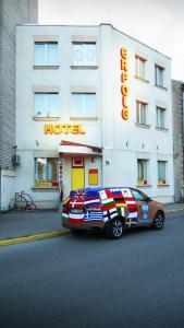 a car parked in front of a hotel at Hotel Erfolg in Daugavpils