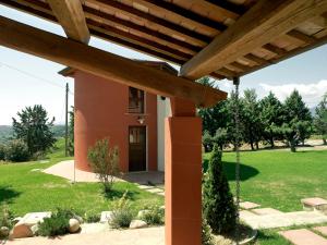 a view of a house from under a wooden pergola at Contado San Lorenzo B&B and Wine in Castilenti
