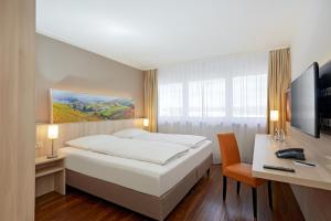 Katil atau katil-katil dalam bilik di H+ Hotel Stuttgart Herrenberg