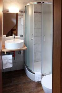 a bathroom with a sink and a shower at Hotel Peiler Garni in Iserlohn