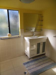 a bathroom with a sink and a mirror at Orchid Beach Retreat Orchid Beach Fraser Island in K'gari Island (Fraser Island) +14 photos