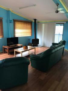 a living room with two couches and a coffee table at Orchid Beach Retreat Orchid Beach Fraser Island in K'gari Island (Fraser Island)