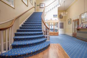 a blue carpeted staircase in a building with a blue floor at The Queens Hotel in Penzance