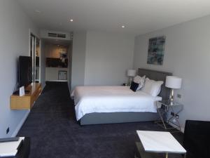 a hotel room with a bed and a television at PrivateStudio in Quay West Building in Melbourne