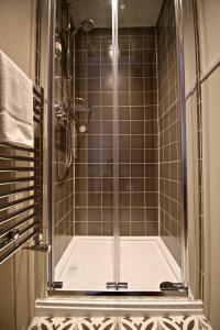a shower with a glass door in a bathroom at The Haven in Windermere