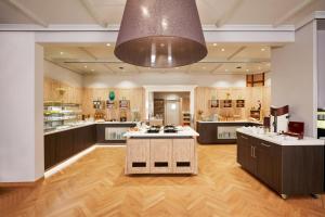 a large kitchen with a large island in the middle at Sunday Hotel Stuttgart Herrenberg in Herrenberg