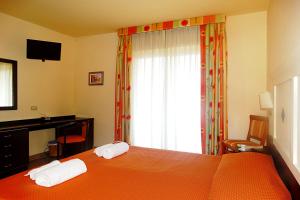 Postel nebo postele na pokoji v ubytování Hotel Orizzonte