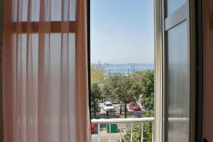a window with a view of a parking lot at Hotel Tritone in Trieste