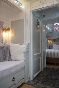 a bedroom with a door leading to a bedroom with a bed at B&B Au Bord De La Source in Soy