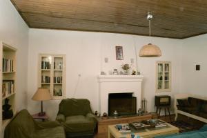 a living room with a couch and a fireplace at Mistra Estates Villa The Vine in Pikouliánika
