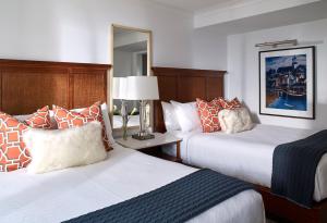 a hotel room with two beds and a mirror at Inn By the Sea in Cape Elizabeth