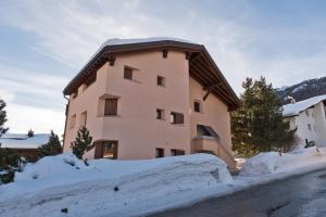 a building with snow in front of it at Chesa Alvra - Celerina in Celerina