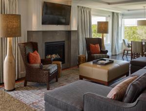 a living room with a couch and a fireplace at Inn By the Sea in Cape Elizabeth