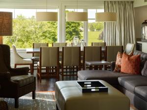 a living room with a couch and a dining room at Inn By the Sea in Cape Elizabeth