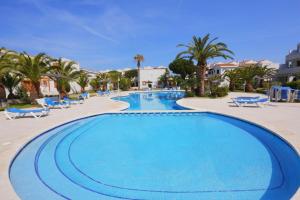ein großer Pool in einem Resort mit Palmen in der Unterkunft Punta Prima Plus Planet Costa Dorada in La Pineda