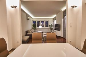 a living room with a white table and chairs at Alpha Residence in Budapest