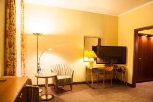 a hotel room with a desk and a television at HOTEL SPECHT Tremonia Group - Dortmund in Dortmund