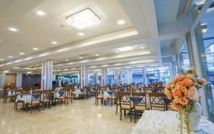 a banquet hall with tables and chairs in a building at Korat Hotel - SHA Plus in Nakhon Ratchasima