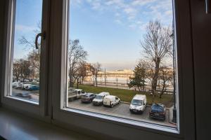 a window with cars parked in a parking lot at Alpha Residence in Budapest