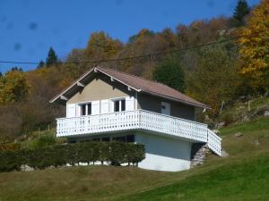 a white house with a balcony on a hill at La Bresse Hautes Vosges Chalet Le Podent in La Bresse