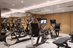 a gym with rows of exercise bikes and treadmills at Maison Bréguet in Paris