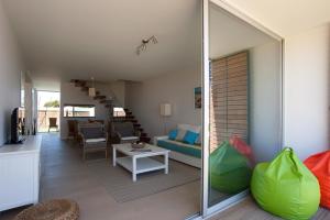 a living room with a couch and a table at Seasagres - Design Villas in Sagres