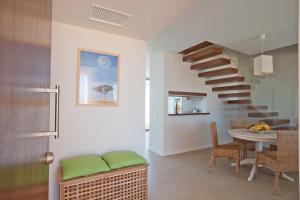 a living room with a spiral staircase and a table at Seasagres - Design Villas in Sagres