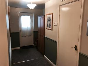 a hallway with a door and a window at The Red Lion Inn & Restaurant in Prestatyn
