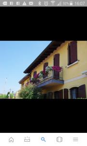 - un bâtiment avec un balcon fleuri dans l'établissement La Stazione Camere Caffè, à Castiglione delle Stiviere