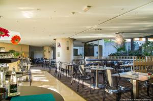 uma sala de jantar com mesas e cadeiras num restaurante em Hotel Cannes Montfleury em Cannes