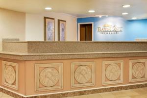 a lobby with a large counter with a sign on it at Baymont by Wyndham Lake City in Lake City +48 photos