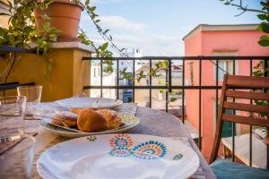 a table with two plates of food on a balcony at Naples Center Apartment in Naples