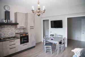 a kitchen and dining room with a table and a chandelier at Green view apartment in Rome