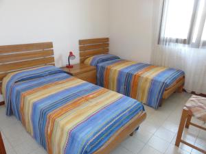 En eller flere senge i et værelse på Villa Fernanda