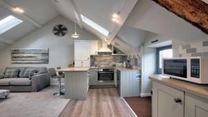 a kitchen and living room in an attic at The Snug - Llyn Peninsula in Pistyll