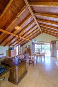 a large living room with wooden ceilings and a table at Seafront Paradise in Plataniás