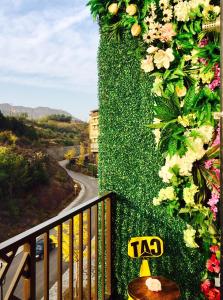 a ivy covered wall with a sign on a balcony at Beijing Tulu Apartment in Miyun