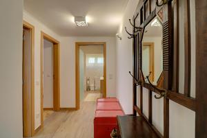 a hallway with a mirror and a red bench at Casa de Benfica in Lisbon