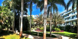 a resort with palm trees and a building at Estelar Playa Manzanillo - All inclusive in Cartagena de Indias