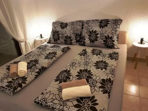 a bed with black and white sheets and pillows at Casa Nostra in Funtana +82 photos