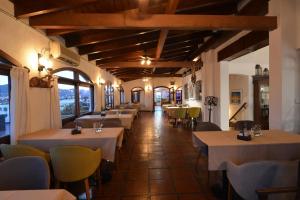 a restaurant with tables and chairs in a room at Hotel Marqués del Lago in Villa Carlos Paz