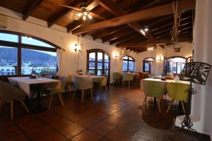 a restaurant with tables and chairs in a room at Hotel Marqués del Lago in Villa Carlos Paz +51 photos