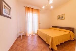 トッレ・サン・ジョヴァンニ・ウジェントにあるCasa Vacanza Francescaのベッドルーム1室(ベッド1台、椅子付)